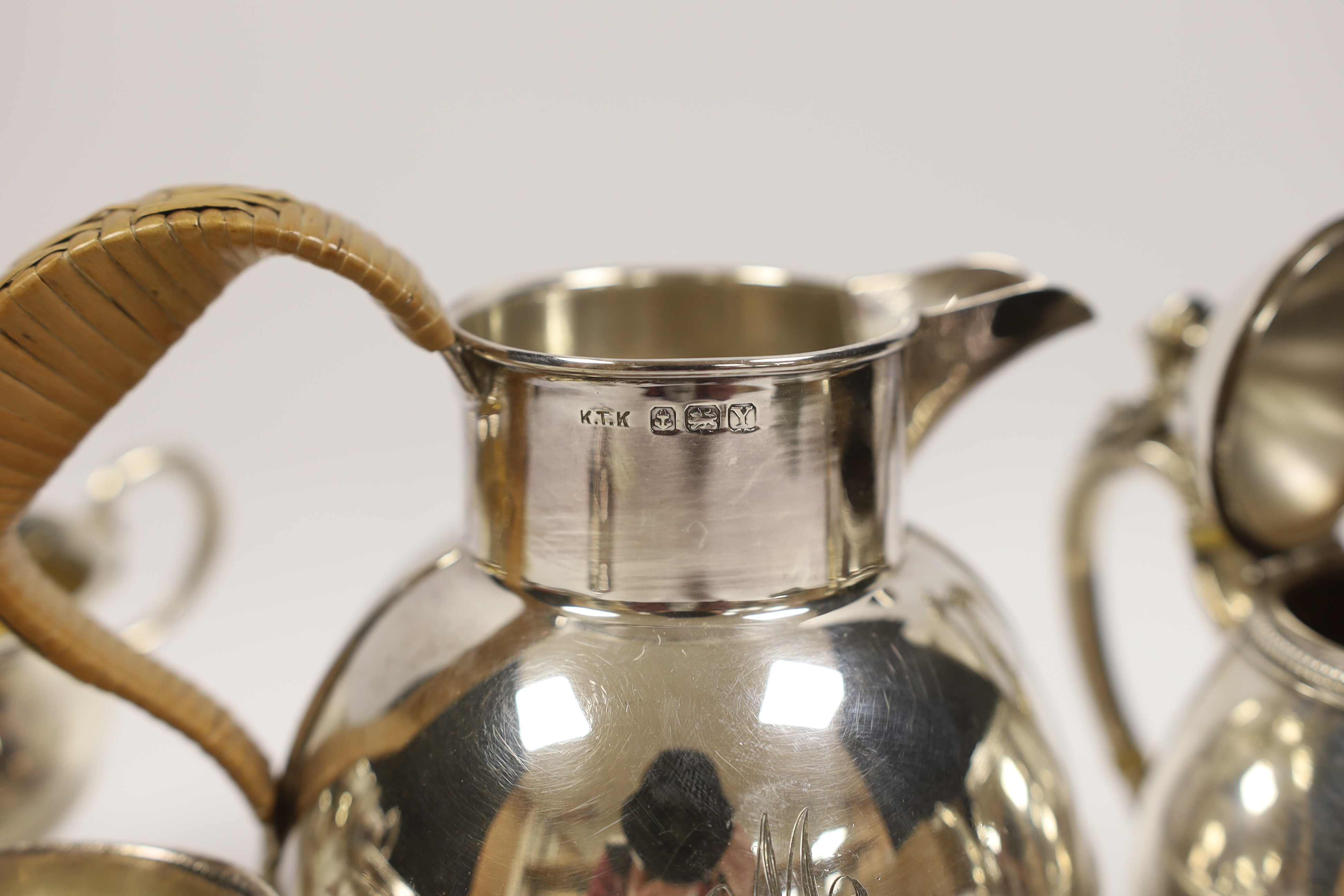 An Elizabeth II silver 'Guernsey' milk can, Kenneth Tyler Key, Birmingham, 1966, height 16.4cm, a sterling bachelor's teapot, sterling cream and sugar (weighted?) and a silver christening mug, gross weight 27.2oz. CITES